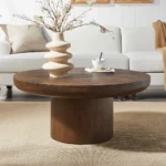 Goldoma round coffee table with wood veneer top and cylindrical legs in dark brown, modern style for living room