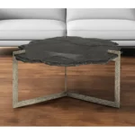 Goldoma 40 inch free form coffee table with distressed black stone top and gold iron base in a living room