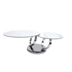 White ceramic coffee table 32 inch round with silver metal base in modern living room setting