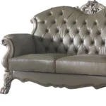 Goldoma 71-inch bone faux leather loveseat with tufted backrest, square arms, and toss pillows