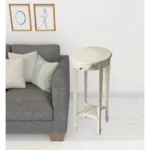 Goldoma 26 inch white oval end table with shelf in a living room setting