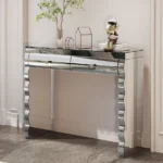 Goldoma modern glass top console table with 2 drawers in a silver finish, placed in an entryway