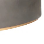 Goldoma 28 inch gray and brass oval coffee table with concrete top in a modern living room