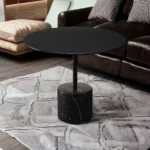 Goldoma 17-inch round farmhouse coffee table with glass top and black metal frame in a modern living room