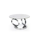White ceramic coffee table 32 inch round with silver metal base in modern living room setting