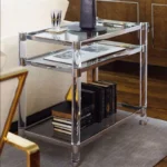 Goldoma 3-tier acrylic coffee table with tempered glass top and stainless steel frame in a modern living room setting
