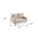 Goldoma 57-inch beige velvet loveseat with tufted seat, track arms, dark brown wood legs, and two toss pillows in a modern living room