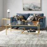 Goldoma 54 inch gold glass and steel coffee table with two shelves in living room