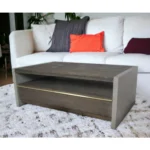 Goldoma 47-inch brown solid wood and dark gray concrete coffee table with drawer and shelf in a modern living room