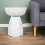 Goldoma 22 inch white distressed solid wood round end table with hand-carved pedestal base in a living room setting