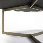 Goldoma 40 inch free form coffee table with distressed black stone top and gold iron base in a living room