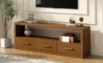 Goldoma modern wood TV stand with adjustable drawers holding a large flat-screen TV in a living room