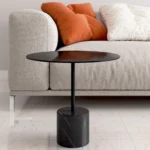 Goldoma 17-inch round farmhouse coffee table with glass top and black metal frame in a modern living room