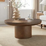 Goldoma round coffee table with wood veneer top and cylindrical legs in dark brown, modern style for living room