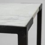 Goldoma 24 inch farmhouse marble end table with white marble top and black abstract iron base in living room setting