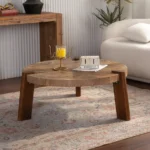 Round herringbone coffee table with solid wood top and tapered legs in a modern living room setting