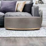 Goldoma 28 inch gray and brass oval coffee table with concrete top in a modern living room