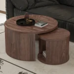 Goldoma round nesting coffee table set of 2 in natural wood and walnut finish, displayed in a modern living room
