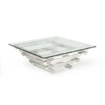 Goldoma 39-inch square glass coffee table with stainless steel sled base and lower shelf in a modern living room setting