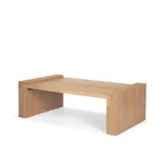 Solid wood coffee table with natural finish and sled base in a modern living room