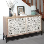 Goldoma vintage carved wood console table with floral doors and black metal base in a living room entryway as a storage sideboard
