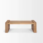 Solid wood coffee table with natural finish and sled base in a modern living room