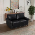 Goldoma black faux leather loveseat with memory foam cushions and wood legs in a modern living room