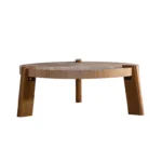 Round herringbone coffee table with solid wood top and tapered legs in a modern living room setting
