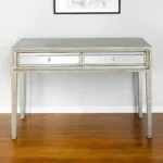 Silver mirrored console table with drawers by Goldoma in antiqued silver finish, 48 inches wide, placed in an entryway
