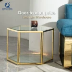 Modern hexagonal glass coffee table with stainless steel frame in a living room setting