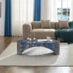 Goldoma oval blue fiberglass coffee table with marble-like finish in a modern living room