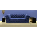 Blue velvet loveseat with gold legs and diamond tufting in a living room