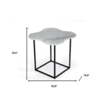 Goldoma 15 inch free form modern white marble end table with black metal base placed beside a sofa in a living room