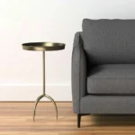 Distressed brass pedestal end table with round raised tray top and iron construction, perfect as accent side table for living room