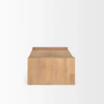 Solid wood coffee table with natural finish and sled base in a modern living room