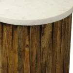 Marble round end table with brown solid wood base and ivory marble top in a living room setting