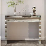 Goldoma modern glass top console table with 2 drawers in a silver finish, placed in an entryway