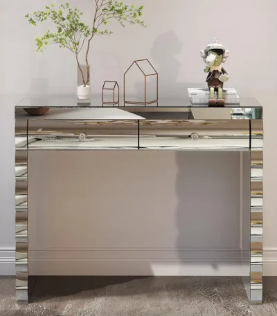 Goldoma modern glass top console table with 2 drawers in a silver finish, placed in an entryway