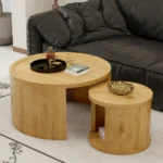 Goldoma round nesting coffee table set of 2 in natural wood and walnut finish, displayed in a modern living room