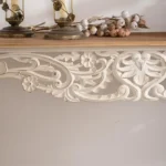 Goldoma French vintage carved distressed white console table in entryway with decor