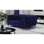 Blue velvet chesterfield loveseat with tufted cushions and silver legs in a living room