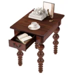 Goldoma narrow sofa side table with drawer in walnut finish, solid wood construction, placed beside a couch in a small living room