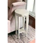Goldoma 26 inch white oval end table with shelf in a living room setting