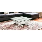 Goldoma 39-inch square glass coffee table with stainless steel sled base and lower shelf in a modern living room setting