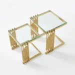 Goldoma gold coffee table set with tempered glass top and gold stainless steel frame in a modern living room
