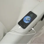Goldoma light gray electric swivel recliner with USB charging in a living room