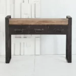 Goldoma narrow console table with drawers in solid oak and black metal sled base, placed in an entryway with decor