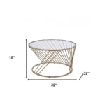 Goldoma 32-inch round tempered glass coffee table with champagne metal base in a modern living room