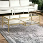 Goldoma 54 inch gold glass and steel coffee table with two shelves in living room
