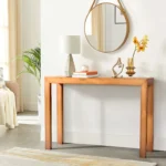 Goldoma 46-inch solid pinewood console table in light brown finish placed in an entryway with decorative accents